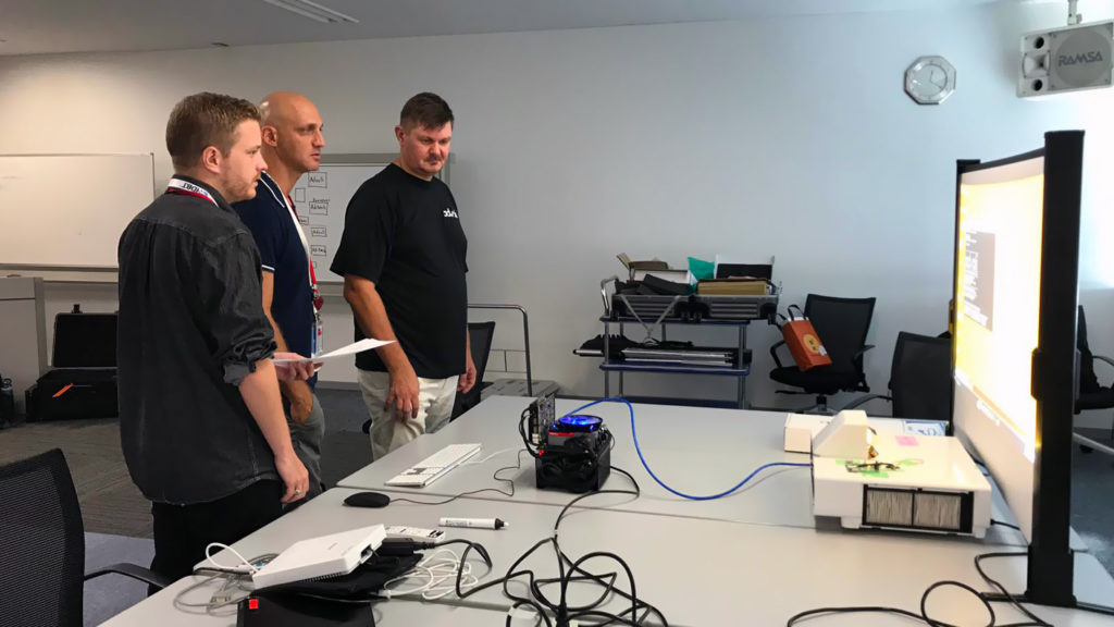 Paul and Clas of advoli testing advoli TA6 Performance with Epson short throw projector at HDBaseT Plugfest 2019
